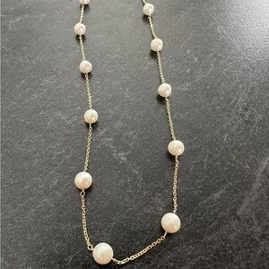 Solid 14k gold round high luster Japanese Akoya pearls station choker necklace.